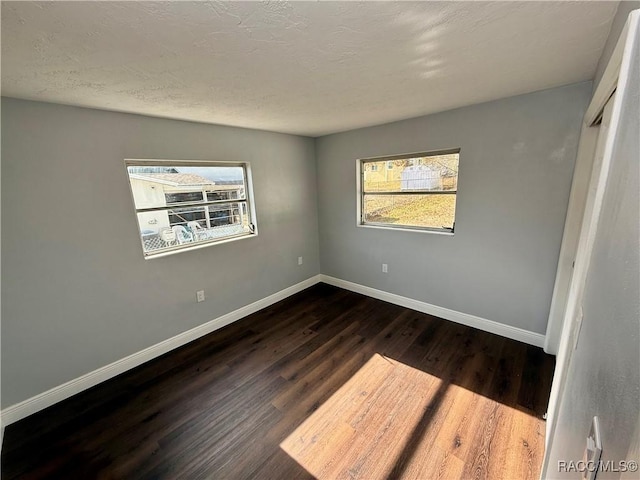 empty room featuring dark hardwood / wood-style flooring