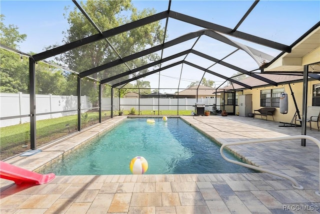 3085 Greynolds Ave, Spring Hill, FL 34608 - view of swimming pool with a fenced backyard, a patio, glass enclosure, and a water slide