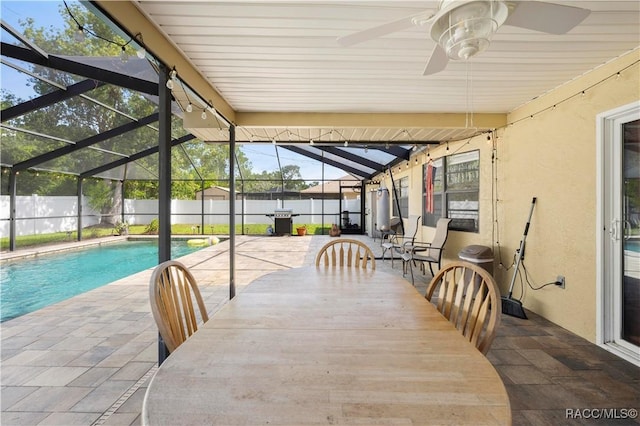 3085 Greynolds Ave, Spring Hill, FL 34608 - sunroom featuring a ceiling fan, water heater, and outdoor dining area