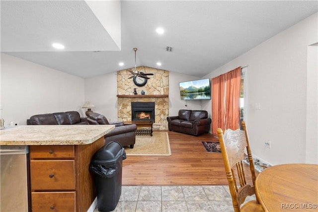 3085 Greynolds Ave, Spring Hill, FL 34608 - kitchen featuring light countertops, lofted ceiling, ceiling fan, a stone fireplace, and open floor plan