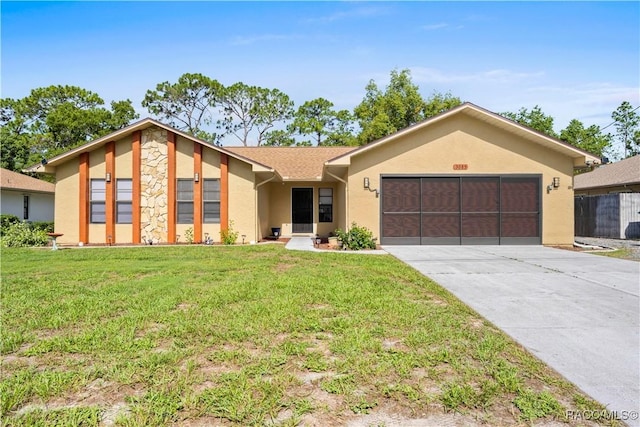 3085 Greynolds Ave, Spring Hill, FL 34608 - view of front of house with stucco siding, an attached garage, concrete driveway, and a front yard