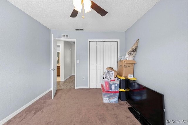 3085 Greynolds Ave, Spring Hill, FL 34608 - bedroom with carpet flooring, a closet, a textured ceiling, and ceiling fan