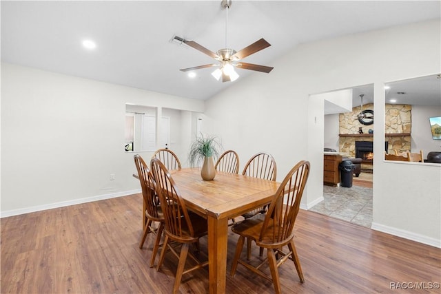 3085 Greynolds Ave, Spring Hill, FL 34608 - dining room with a ceiling fan, vaulted ceiling, wood finished floors, and a fireplace