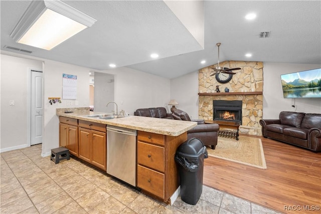 3085 Greynolds Ave, Spring Hill, FL 34608 - kitchen with dishwasher, ceiling fan, light countertops, a peninsula, and a fireplace
