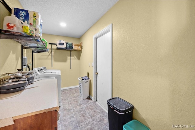 3085 Greynolds Ave, Spring Hill, FL 34608 - washroom featuring independent washer and dryer, light tile patterned floors, a textured wall, and a textured ceiling