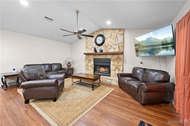 3085 Greynolds Ave, Spring Hill, FL 34608 - living area with wood finished floors, lofted ceiling, ceiling fan, and a fireplace