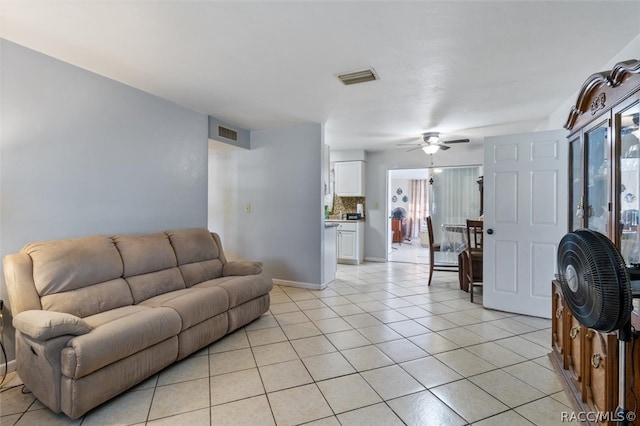 tiled living room featuring ceiling fan