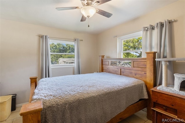 tiled bedroom featuring ceiling fan