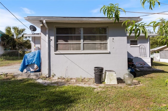 view of property exterior with a lawn