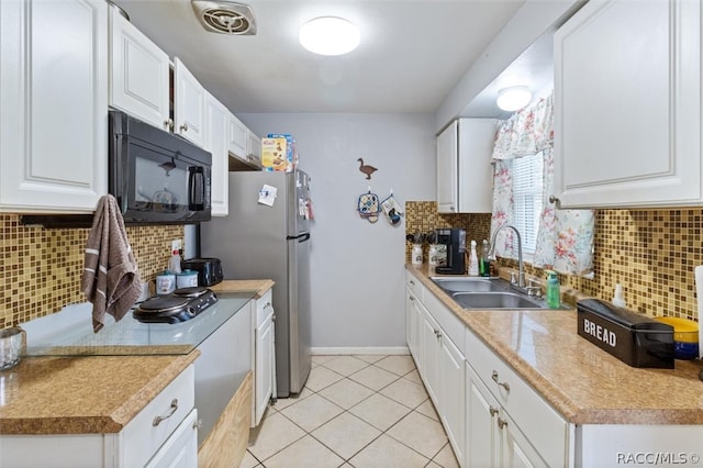 kitchen with decorative backsplash, white cabinetry, and sink