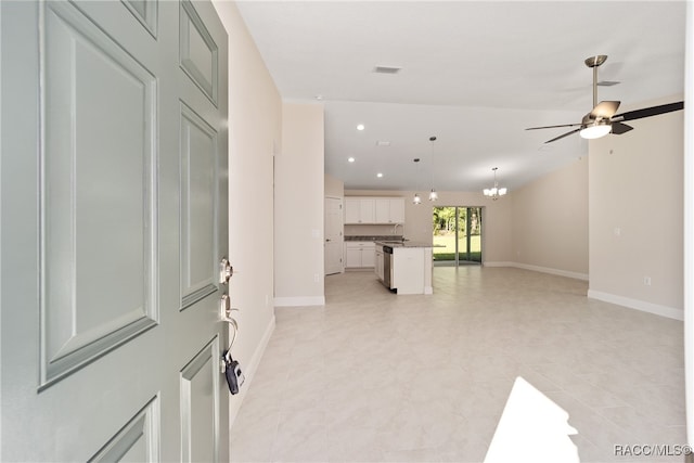 interior space featuring sink and ceiling fan with notable chandelier