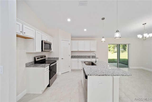 kitchen featuring stainless steel appliances, white cabinetry, sink, and an island with sink