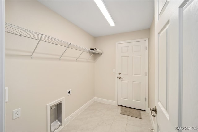 washroom with electric dryer hookup and light tile patterned floors