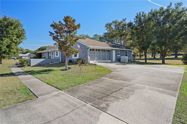 ranch-style house with a garage and a front lawn