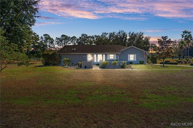 ranch-style house with a lawn