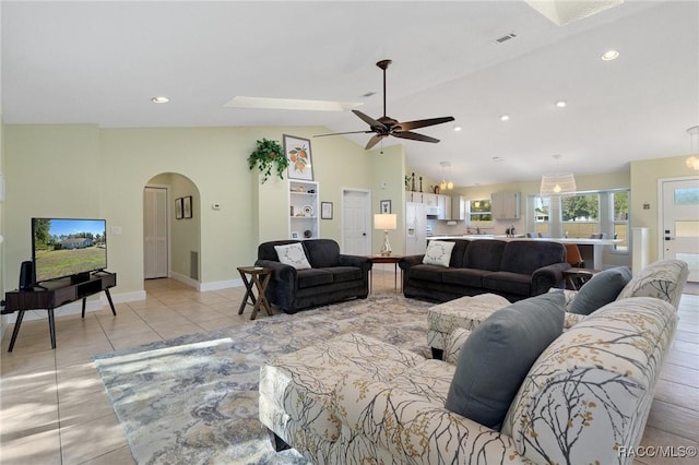 tiled living room featuring ceiling fan and lofted ceiling