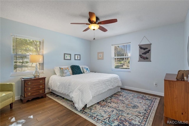 bedroom with ceiling fan, a textured ceiling, and hardwood / wood-style flooring