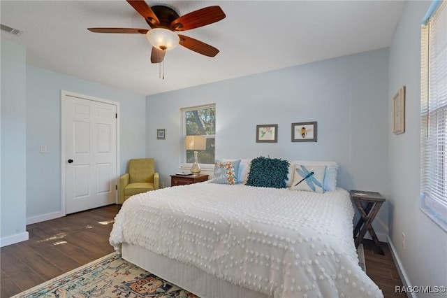 bedroom featuring ceiling fan and dark wood-type flooring