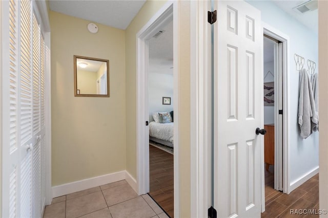 hallway with light tile patterned floors