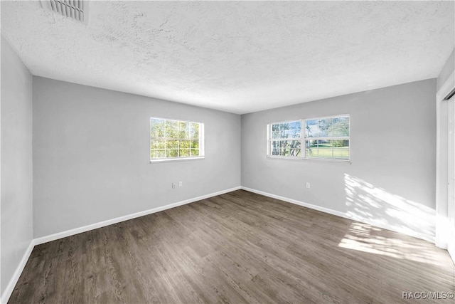 28 Truman Blvd, Beverly Hills, FL 34465 - spare room with healthy amount of natural light, wood finished floors, baseboards, and a textured ceiling