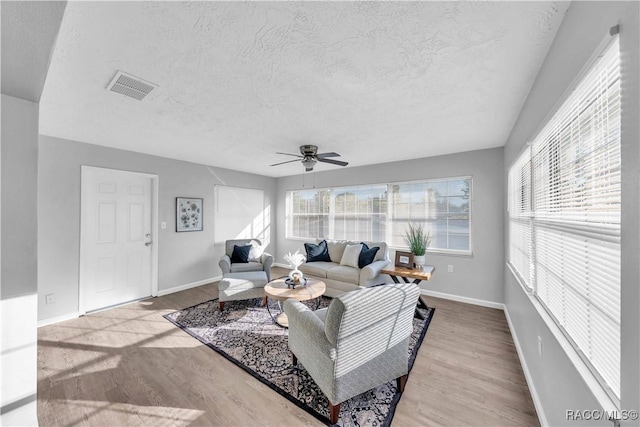 28 Truman Blvd, Beverly Hills, FL 34465 - living area with a textured ceiling, plenty of natural light, wood finished floors, ceiling fan, and baseboards