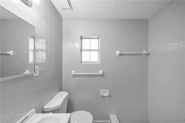 28 Truman Blvd, Beverly Hills, FL 34465 - bathroom with toilet, a textured ceiling, and tile walls