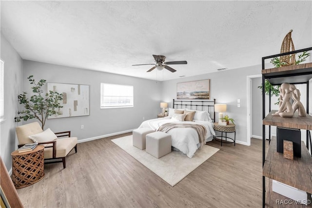 28 Truman Blvd, Beverly Hills, FL 34465 - bedroom featuring baseboards, wood finished floors, a ceiling fan, and a textured ceiling