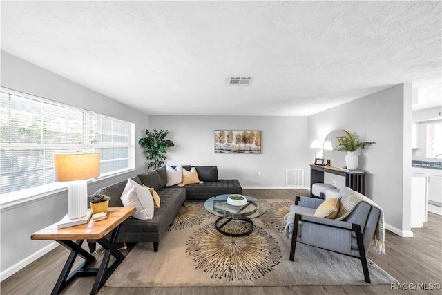 28 Truman Blvd, Beverly Hills, FL 34465 - living area featuring wood finished floors, baseboards, and a textured ceiling