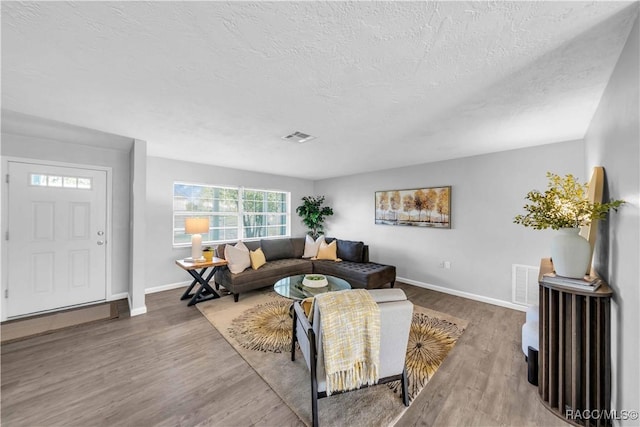 28 Truman Blvd, Beverly Hills, FL 34465 - living room with wood finished floors, baseboards, and a textured ceiling