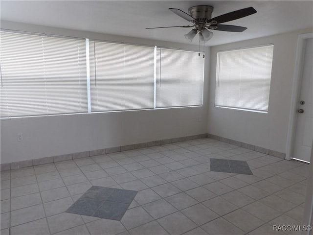 tiled empty room with ceiling fan