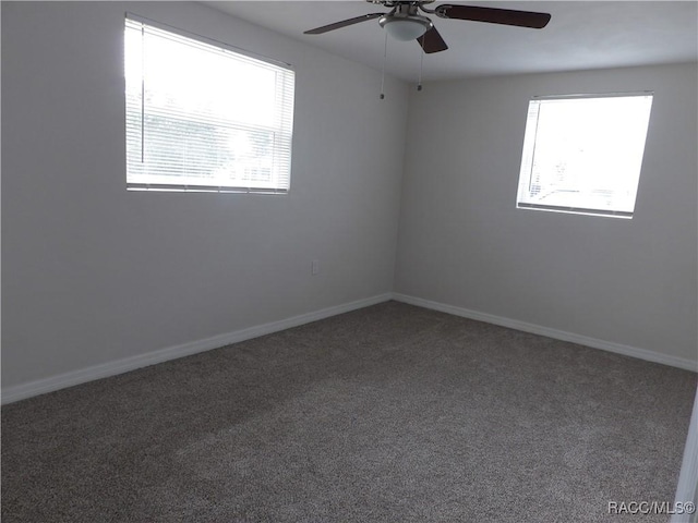 unfurnished room with ceiling fan and carpet floors