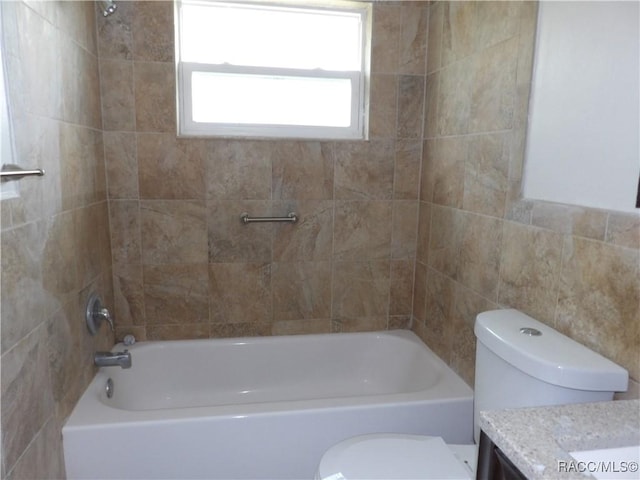 full bathroom with tiled shower / bath combo, toilet, and vanity