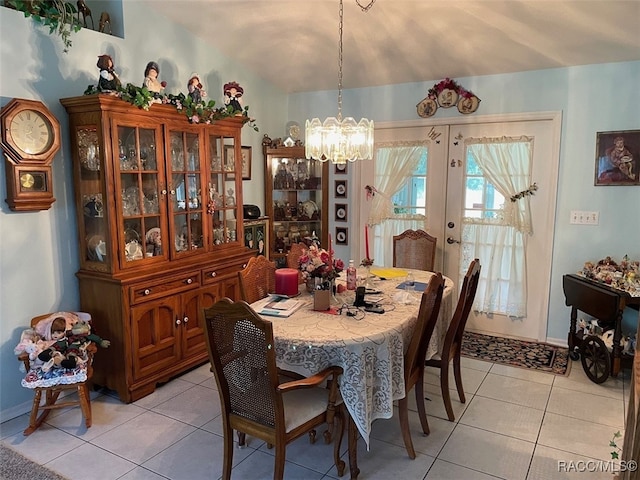 tiled dining room featuring an inviting chandelier and french doors