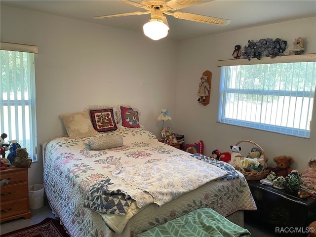 bedroom with multiple windows and ceiling fan