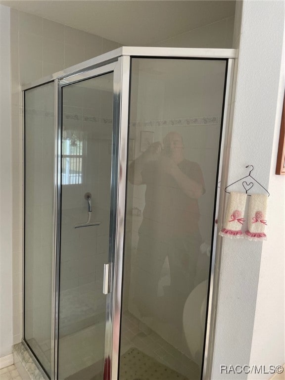 bathroom with vaulted ceiling and an enclosed shower