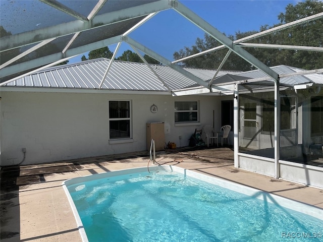 view of pool with a lanai and a patio