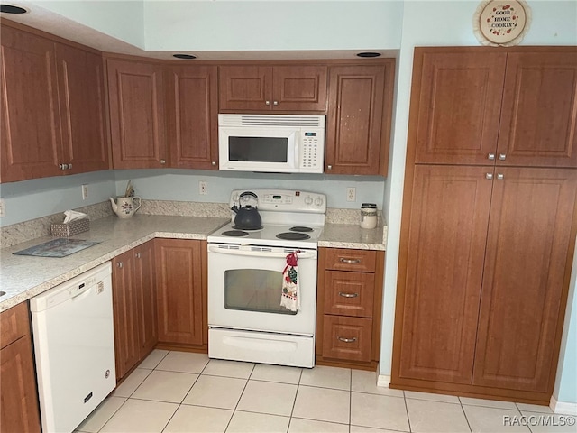 kitchen with light tile patterned floors and white appliances