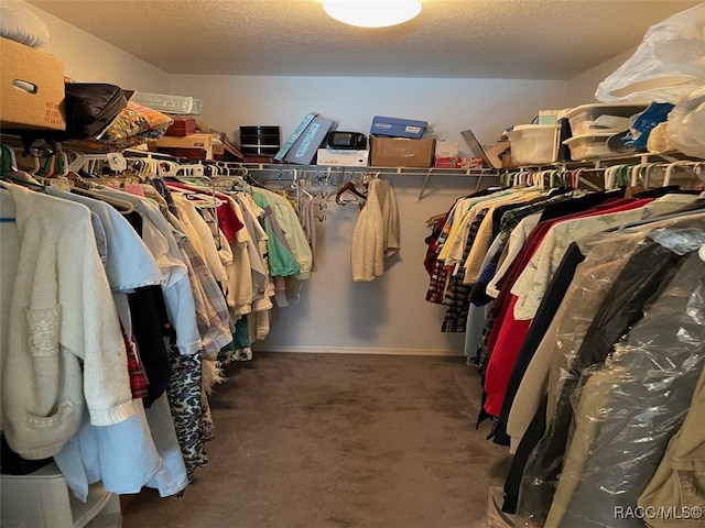 spacious closet featuring dark carpet