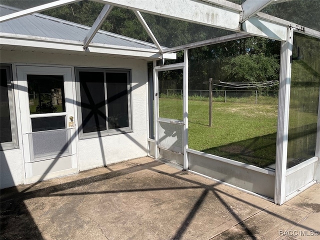 unfurnished sunroom featuring lofted ceiling