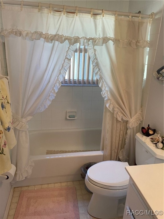 full bathroom with shower / bathtub combination with curtain, vanity, and toilet