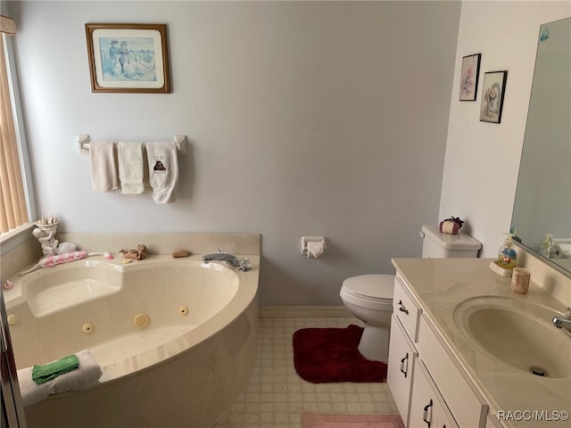 bathroom featuring vanity, toilet, and a tub to relax in