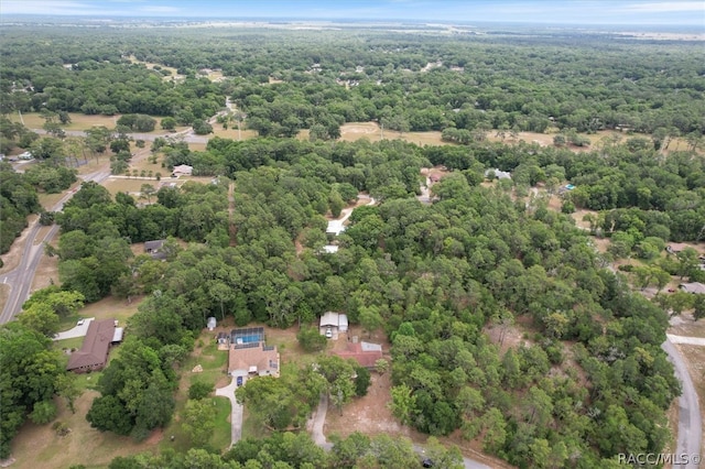 birds eye view of property with a view of trees