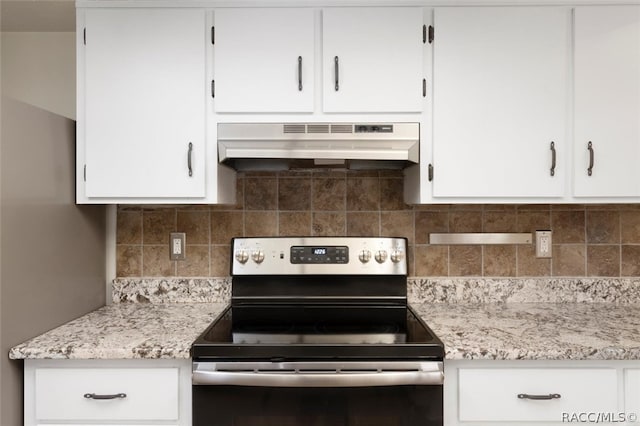 kitchen with stainless steel electric stove, backsplash, white cabinets, and under cabinet range hood