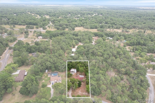 birds eye view of property featuring a forest view