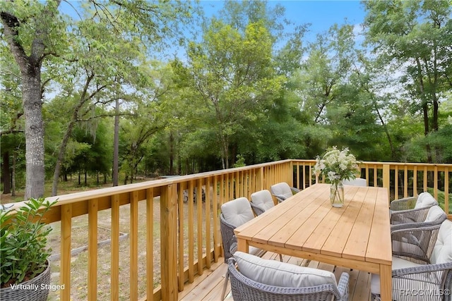 wooden terrace featuring outdoor dining space