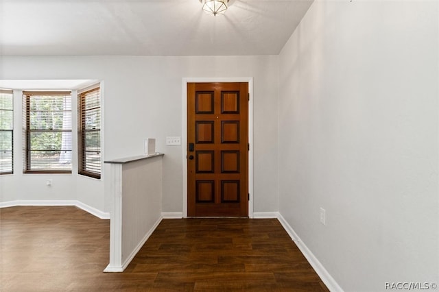 entrance foyer featuring dark wood-type flooring and baseboards