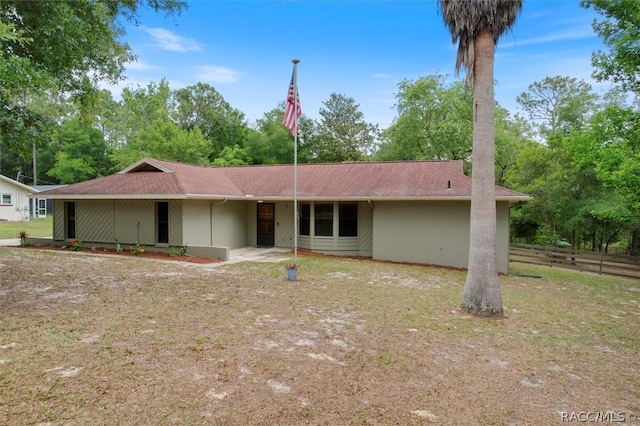 single story home featuring fence