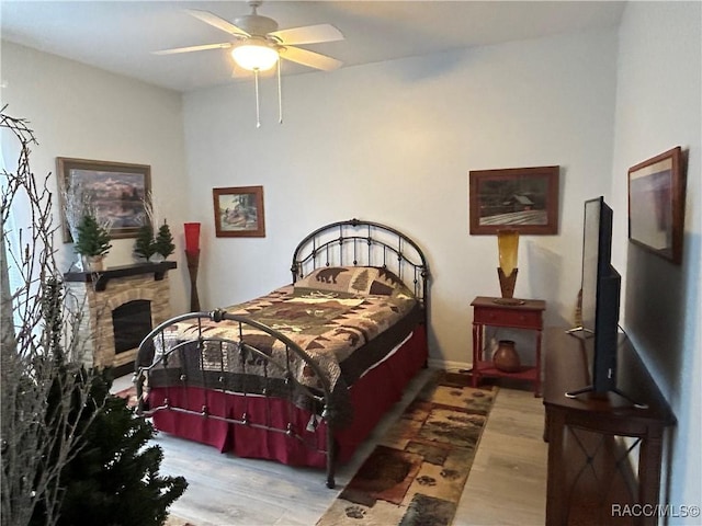 5774 N Lamp Post Dr, Beverly Hills, FL 34465 - bedroom featuring wood finished floors, a fireplace, and a ceiling fan