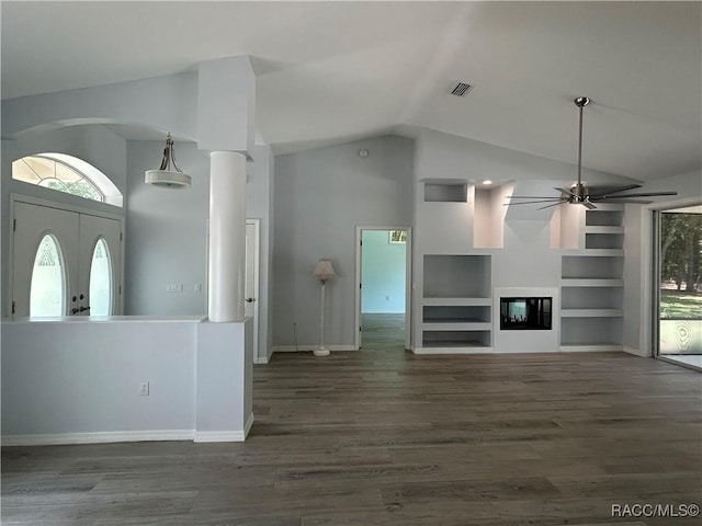 5774 N Lamp Post Dr, Beverly Hills, FL 34465 - unfurnished living room with a ceiling fan, healthy amount of natural light, wood finished floors, built in features, and high vaulted ceiling