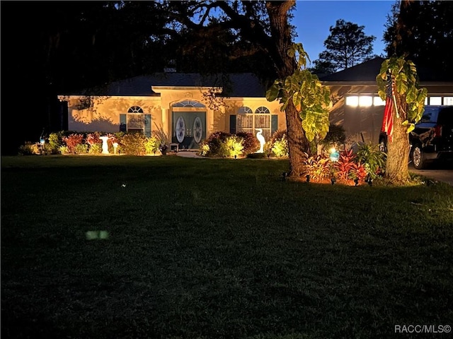 5774 N Lamp Post Dr, Beverly Hills, FL 34465 - view of front of house with a yard and stucco siding
